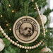 A Christmas tree decorated with ornaments, including a circular ornament featuring a dog's face and the text "DANDIE DINMONT TERRIER".