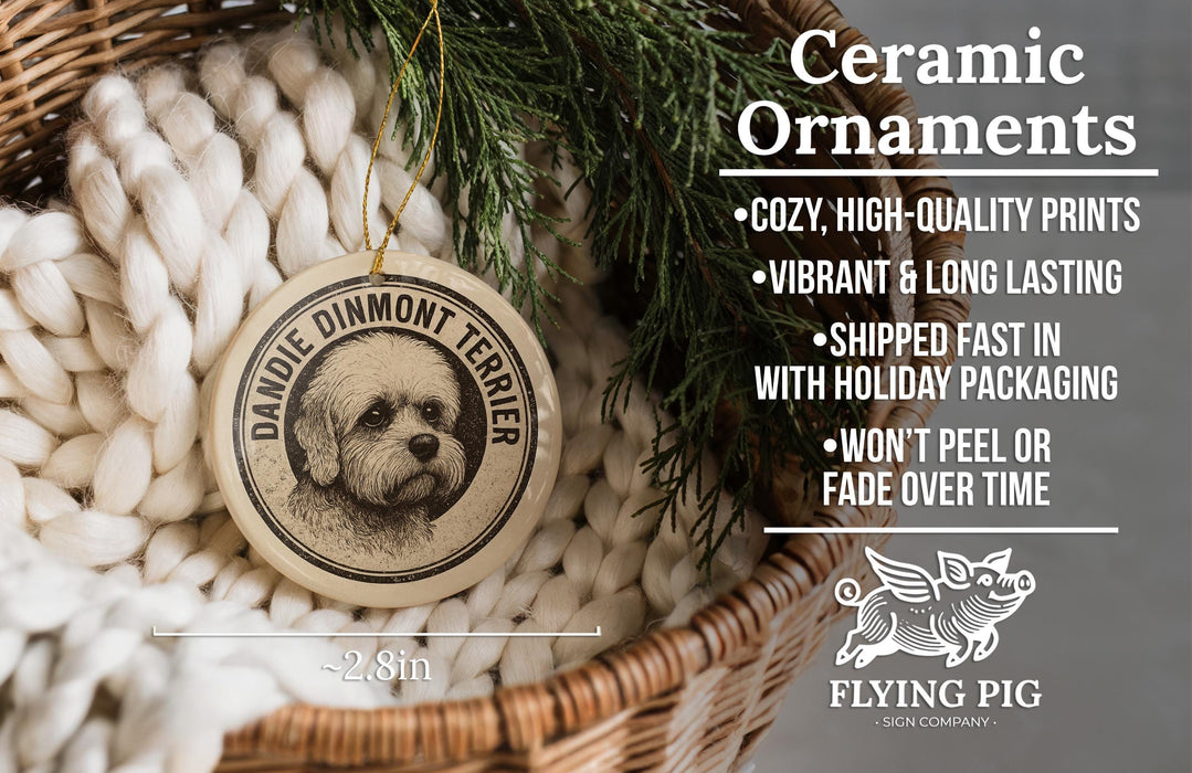 Ceramic ornaments featuring a Dandie Dimmont Terrier dog, with a wicker basket and greenery in the background.