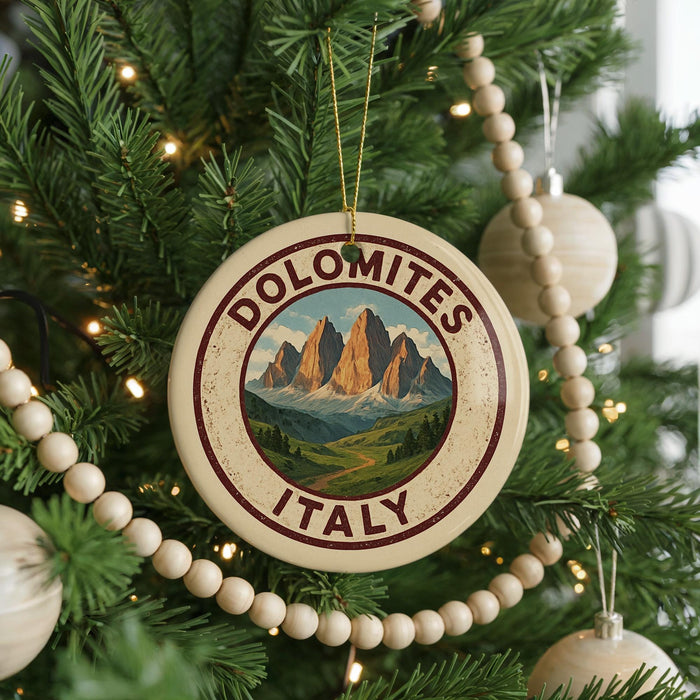 A round ornament on a Christmas tree with the text "DOLOMITES ITALY" and a mountain landscape design.