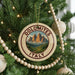 A round ornament on a Christmas tree with the text "DOLOMITES ITALY" and a mountain landscape design.