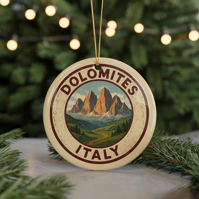 A circular ornament with the text "DOLOMITES ITALY" and a mountain landscape design, hanging from a string.