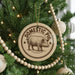A Christmas tree decorated with ornaments, including a circular ornament with a pig illustration and the text "DOMESTIC PIG".