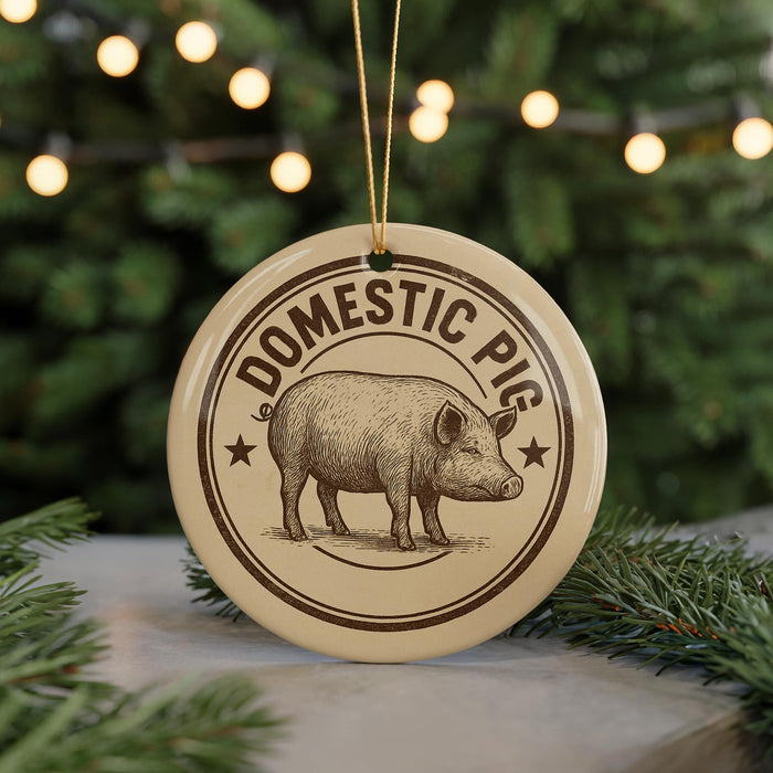 A round ornament with the text "DOMESTIC PIG" and an illustration of a pig is displayed in front of a Christmas tree with twinkling lights.