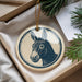 A circular ornament featuring a donkey's head is displayed in a box, surrounded by pine branches.