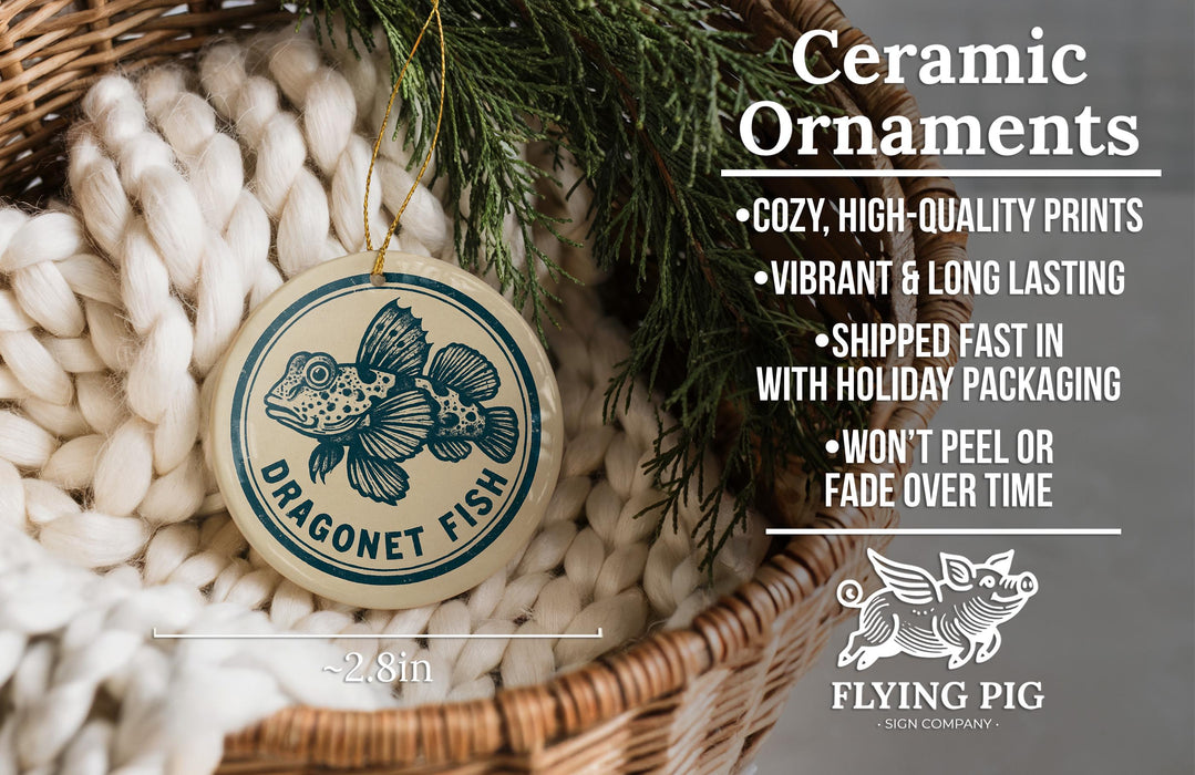 Ceramic ornaments featuring a dragonnet fish design, hanging from a wicker basket with greenery.