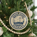 A circular ornament on a Christmas tree, featuring the text "DÜSSELLDORF GERMANY" and an illustration of the Düsseldorf Tower.