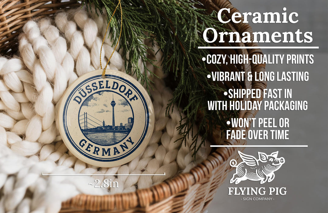 Ceramic ornaments, specifically a Dusseldorf Germany ornament, are displayed in a woven basket.
