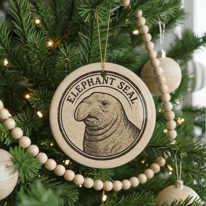 A Christmas tree decorated with ornaments, including a circular ornament featuring an elephant seal.