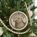 A Christmas tree decorated with ornaments, including a circular ornament featuring an elephant seal.