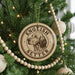 A Christmas tree decorated with ornaments, including a circular ornament with the text "ENGLISH SETTER" and a depiction of a dog's head.