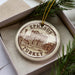 A circular ornament with the text "EPHISSUS TURKEY" printed on it, surrounded by pine branches.