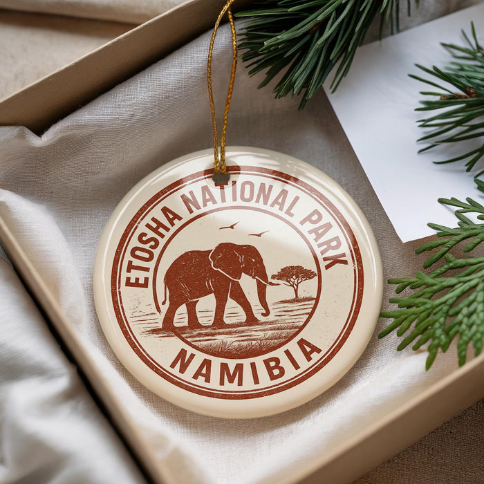 A circular ornament with the text "ETOSHA NATIONAL PARK NAMIBIA" printed on it, hanging from a string.