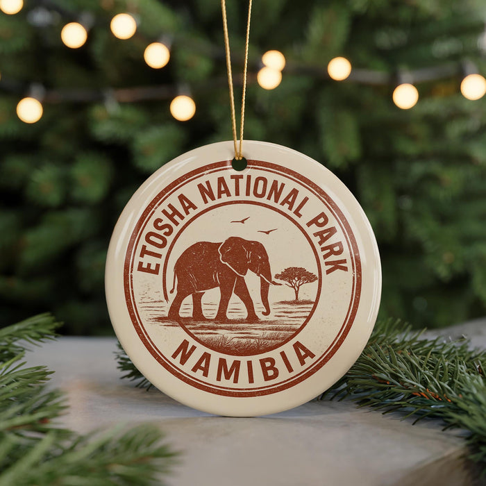 A circular ornament with the text "ETOSHA NATIONAL PARK NAMIBIA" and an illustration of an elephant, hanging from a string.