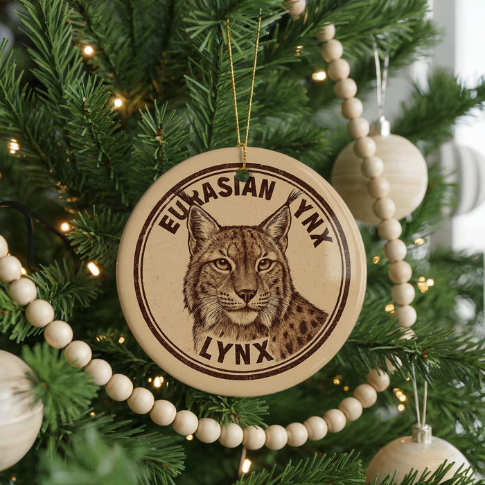 A Christmas tree decorated with ornaments, including a circular ornament featuring a picture of a lynx.