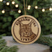 A circular ornament featuring a close-up image of a lynx, a wild cat, with the text "EURASIAN YNX LYNX" around the edge.