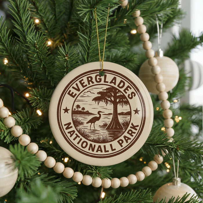 A Christmas tree decorated with ornaments, including a circular ornament with the text "EVERGLADES NATIONAL PARK" and a bird silhouette.