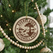 A Christmas tree decorated with ornaments, including a circular ornament with the text "EVERGLADES NATIONAL PARK" and a bird silhouette.