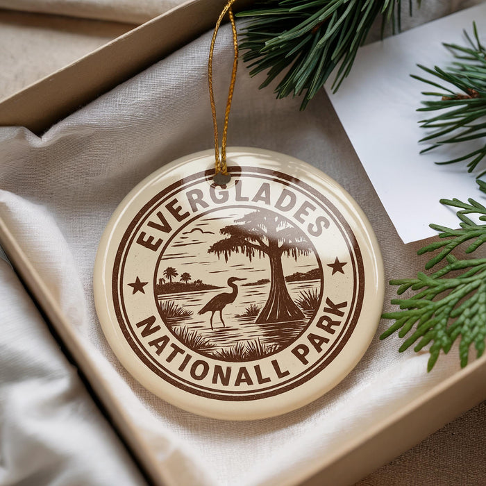 A circular ornament with the text "EVERGLADES NATIONAL PARK" printed on it, surrounded by a tree and pine branches.
