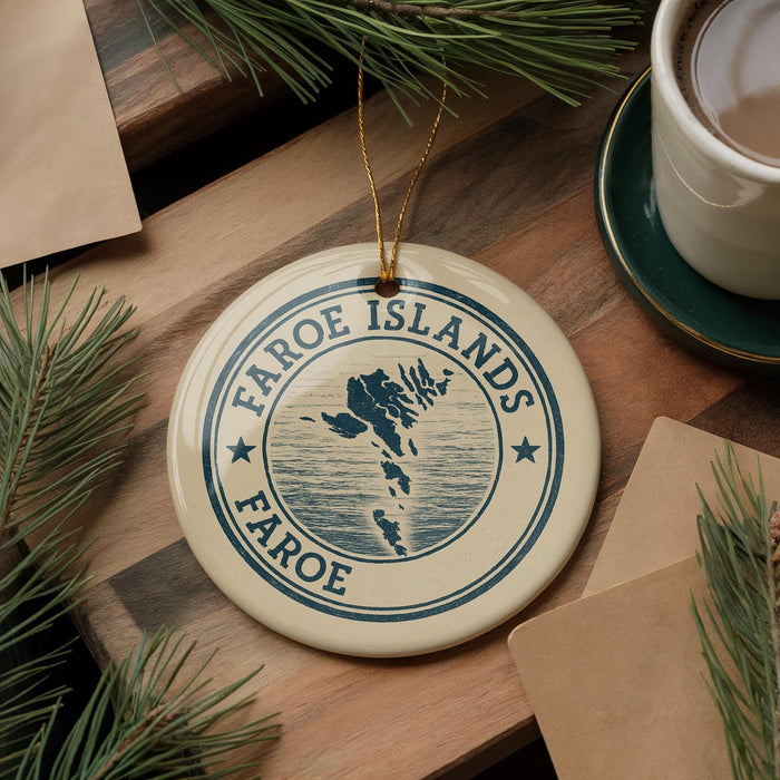 a circular ornament with the text "FAROE ISLANDS" and a map of the Faroe Islands, placed on a wooden surface.