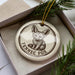 A ceramic ornament in a box, featuring a fennec fox illustration and the text "Fennec Fox" printed on it.