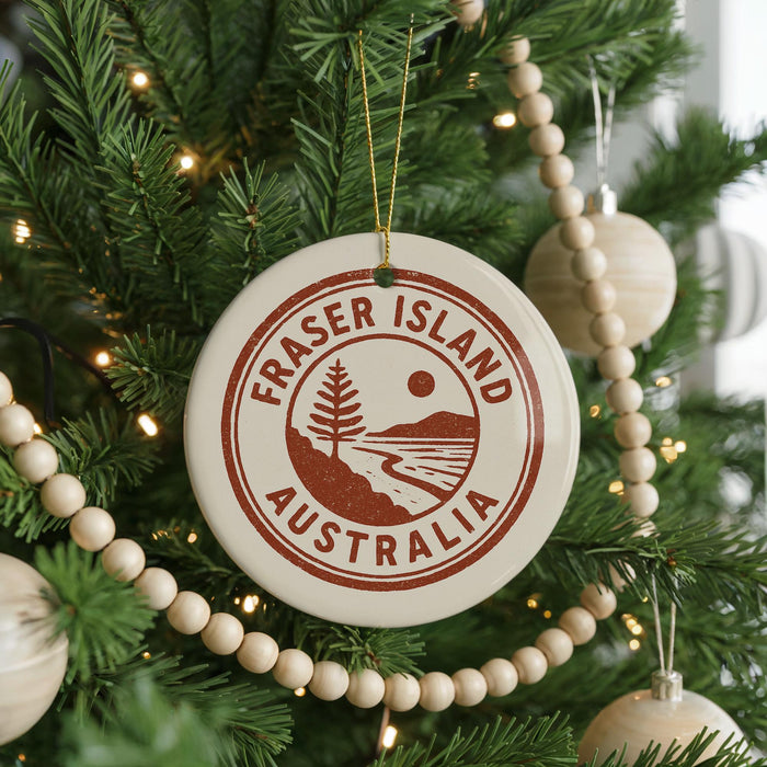 A Christmas tree decorated with ornaments, including a circular ornament with the text "FRASER ISLAND AUSTRALIA" on it.