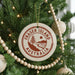 A Christmas tree decorated with ornaments, including a circular ornament with the text "FRASER ISLAND AUSTRALIA" on it.
