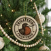 A circular ornament on a Christmas tree, featuring a bird illustration and the text "Frigatebird" in a decorative font.