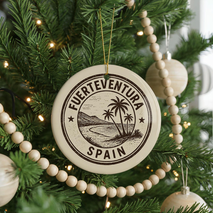 A circular ornament on a Christmas tree, featuring a palm tree and the text "Fuerteventura" and "Spain".
