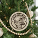 A circular ornament on a Christmas tree, featuring a palm tree and the text "Fuerteventura" and "Spain".