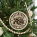 A Christmas tree decorated with ornaments, including a circular ornament with a turtle design and the text "GALLÁPAGOS TORTOISE" printed on it.