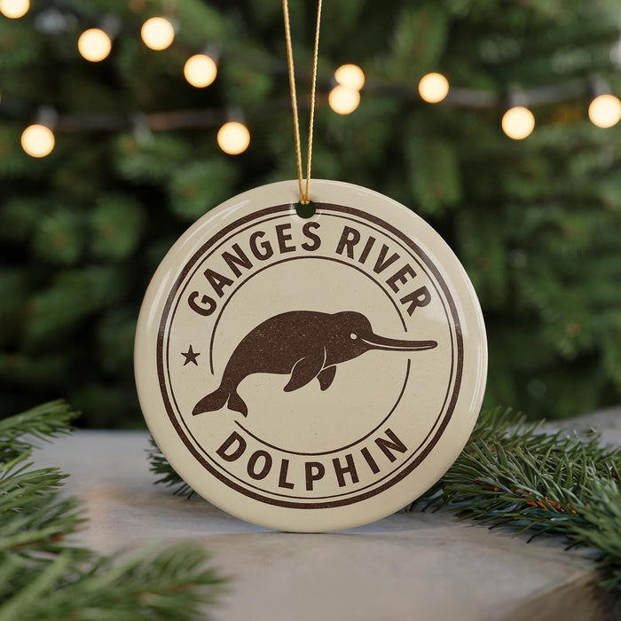 A circular ornament with the text "Ganges River Dolphin" and a graphic of a dolphin is displayed on a Christmas tree.