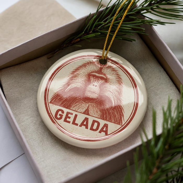 A circular ornament with a red and white design featuring a monkey's face, hanging from a string.