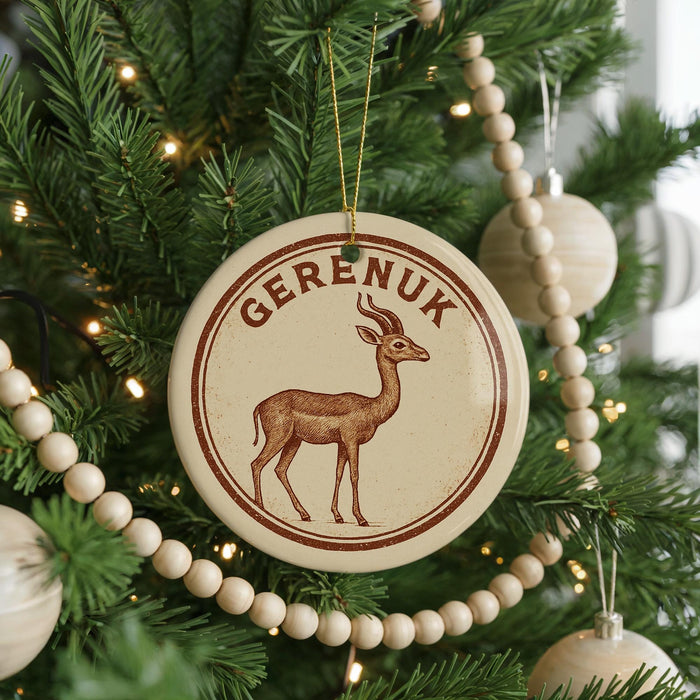 A circular ornament with a deer image and the word "Gereux" on it, hanging on a Christmas tree.