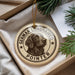 A round ornament with a German Longhaired Pointer dog image and the text "German Longhaired Pointer" printed on it, hanging from a string.