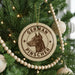 A Christmas tree decorated with ornaments, including a circular ornament with a dog's head and the text "GERMAN PINSCHER" printed on it.