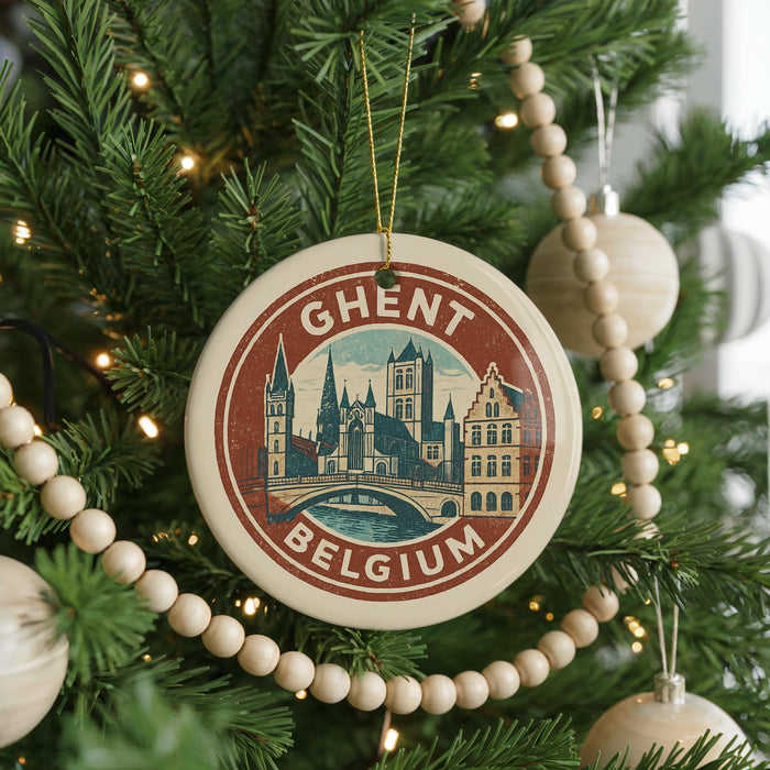 A circular ornament on a Christmas tree, featuring a picture of a city skyline and the text "GHENT BELGIA".