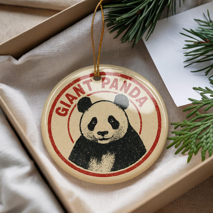 A round ornament with a panda bear image and the text "GIANT PANDAS" printed on it, hanging from a string.