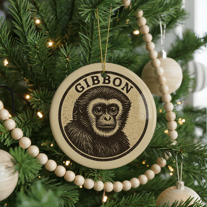 A Christmas tree decorated with ornaments, including a large circular ornament with a monkey's face and the word "GIBBON" written on it.