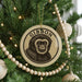 A Christmas tree decorated with ornaments, including a large circular ornament with a monkey's face and the word "GIBBON" written on it.