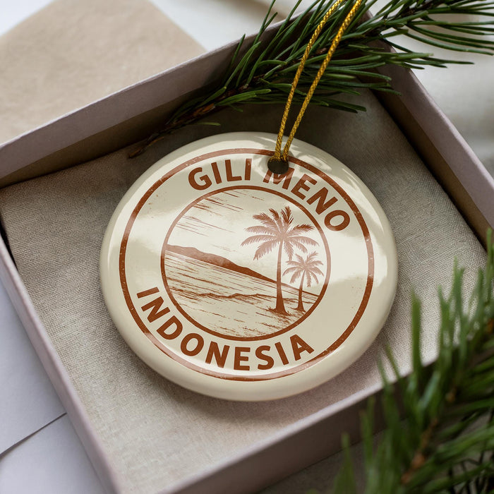 A circular ornament with the text "GILI MENO INDONESIA" printed on it, surrounded by a decorative border and a palm tree illustration.