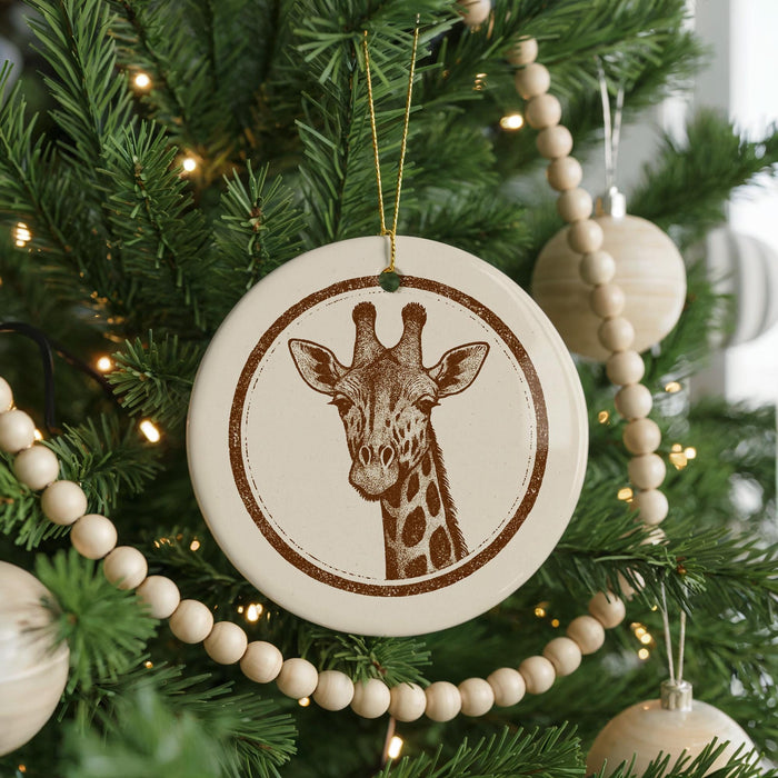 A Christmas tree decorated with ornaments, including a circular ornament featuring a giraffe's face.