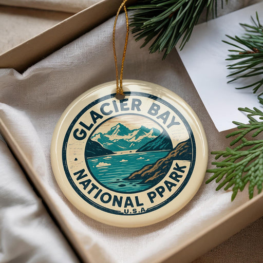 A circular ornament with the text "GLACIER BAY NATIONAL PARK" and a mountain landscape design, hanging from a string.