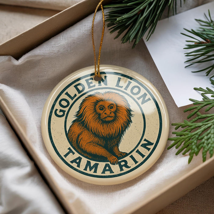 A round ornament with a golden lion and tamarin monkey design, hanging from a string.