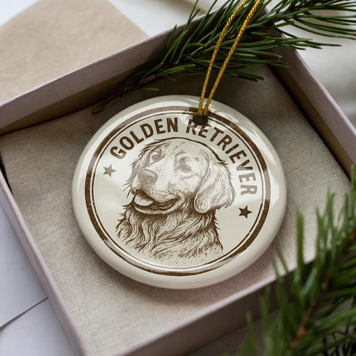 A ceramic ornament in a box, featuring a detailed illustration of a golden retriever dog.
