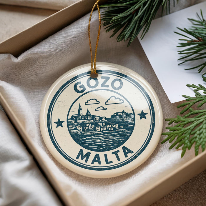 A circular ornament with the text "GOZO MALTA" printed on it, hanging from a string.