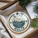 A circular ornament with the text "GOZO MALTA" printed on it, hanging from a string.