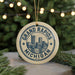 A circular ornament with the text "GRAND RAPIDS MICHIGAN USA" printed on it, featuring an illustration of a city skyline.