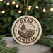 A circular ornament with the text "GRAZ AUSTRIA" and an illustration of a clock tower, hanging from a string.