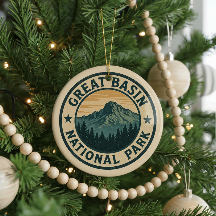 A Christmas tree decorated with ornaments, including a circular ornament with the text "GREAT BASIN NATIONAL PARK" and a mountain landscape design.