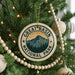 A Christmas tree decorated with ornaments, including a circular ornament with the text "GREAT BASIN NATIONAL PARK" and a mountain landscape design.
